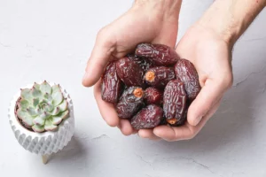 a woman holding dates in her hands